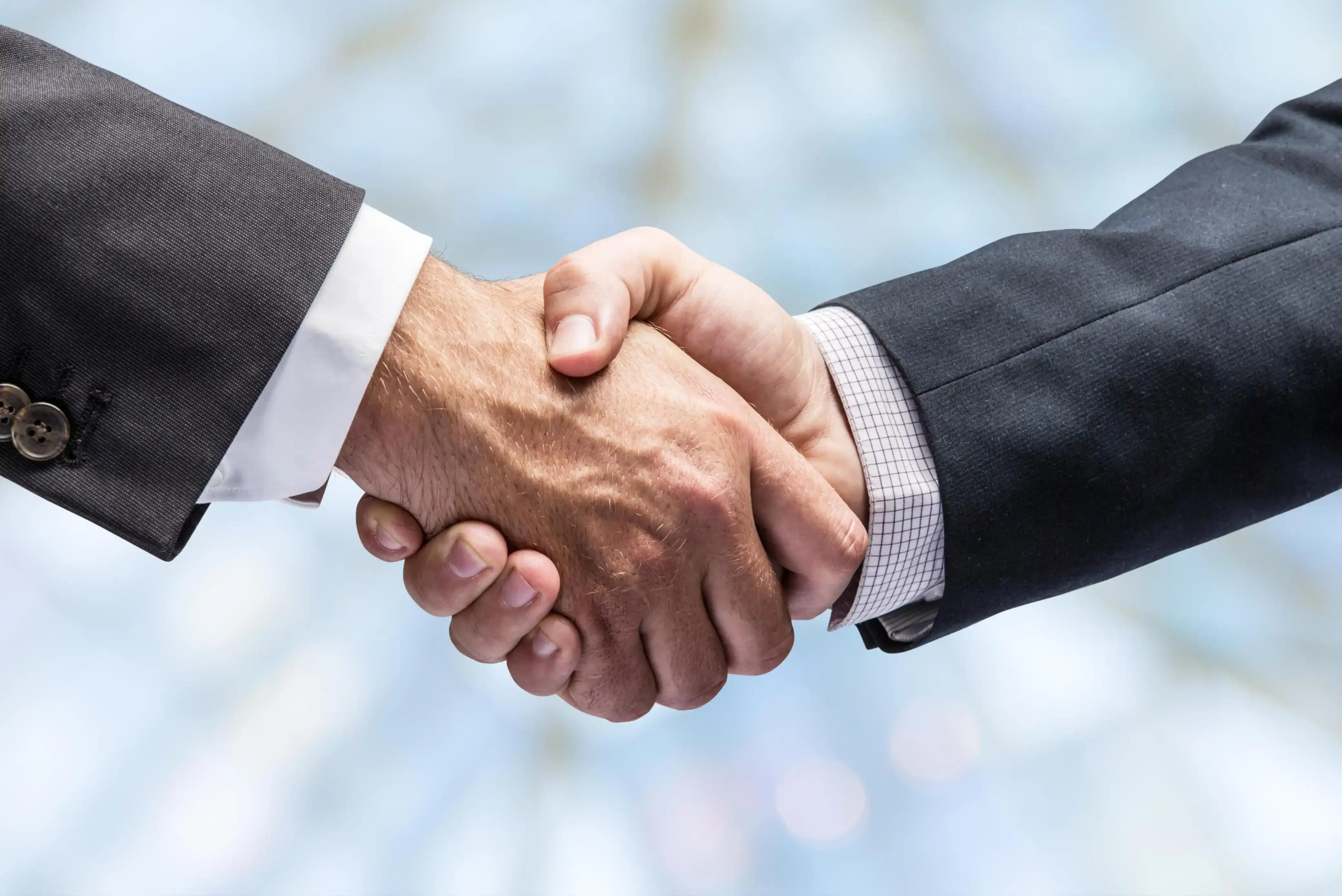 Handshake between two professionals representing collaboration at Mythri Builders